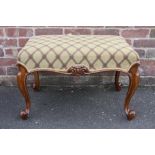 AN ANTIQUE MAHOGANY RECTANGULAR STOOL, having a modern upholstered seta, supported by four slender