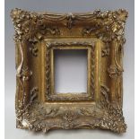 A 19TH CENTURY GOLD SWEPT PORTRAIT MINIATURE FRAME, frame W 8 cm, rebate 11 x 9 cm