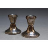 A PAIR OF MODERN HALLMARKED SILVER SQUAT CANDLESTICKS - BIRMINGHAM 1992, having filled bases, H 6.