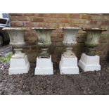 A SET OF FOUR ANTIQUE CAST METAL CAMPANA URNS ON LATER BASES, the urns of typical form, overall H 75