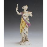 AN ANTIQUE HARD PASTE FIGURINE, as a female figure reading from a book, in the style of Serves,