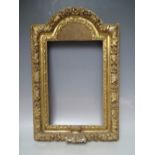 A 17TH CENTURY CONTINENTAL DECORATIVE CARVED WOODEN FRAME WITH ARCHED TOP, frame W 7 cm, rebate 40 x