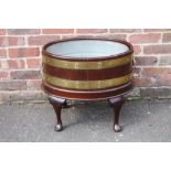 A REPRODUCTION MAHOGANY OVAL WINE COOLER IN THE GEORGIAN STYLE, having modern tin removable liner,