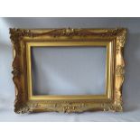 A 19TH CENTURY DECORATIVE GOLD SWEPT FRAME WITH GOLD SLIP, frame W 10 cm, slip rebate 61 x 41 cm,