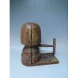 AN EARLY 20TH CENTURY WOODEN ADJUSTABLE MILLINERS HAT BLOCK STRETCHER S/D