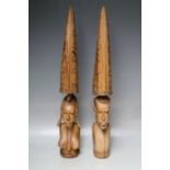 A PAIR OF CARVED HARDWOOD TRIBAL FIGURES, H 55 cm