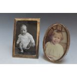 TWO HALLMARKED SILVER PHOTO FRAMES, consisting of an oval example by Sanders and Mackenzie -