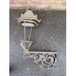 A CAST IRON EXTERIOR / COURTYARD LANTERN ON WALL BRACKET, with copper hood, approx. overall H 98 cm,