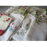 A COLLECTION OF VINTAGE EMBROIDERED AND EMBELLISHED TABLE LINEN ETC, comprising eight table cloths