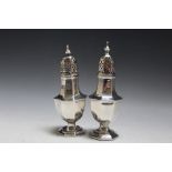A PAIR OF HALLMARKED SILVER CASTORS, hallmarks indistinct, various bumps and faults, one with filled