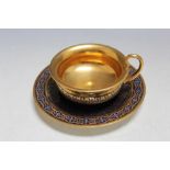 A SEVRES TYPE HIGHLY GILDED CABINET CUP AND SAUCER, on cobalt blue background, marks to both cup and