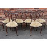 A SET OF SIX VICTORIAN MAHOGANY CROWN BACKED DINING CHAIRS, with carved top and mid rails, raised on