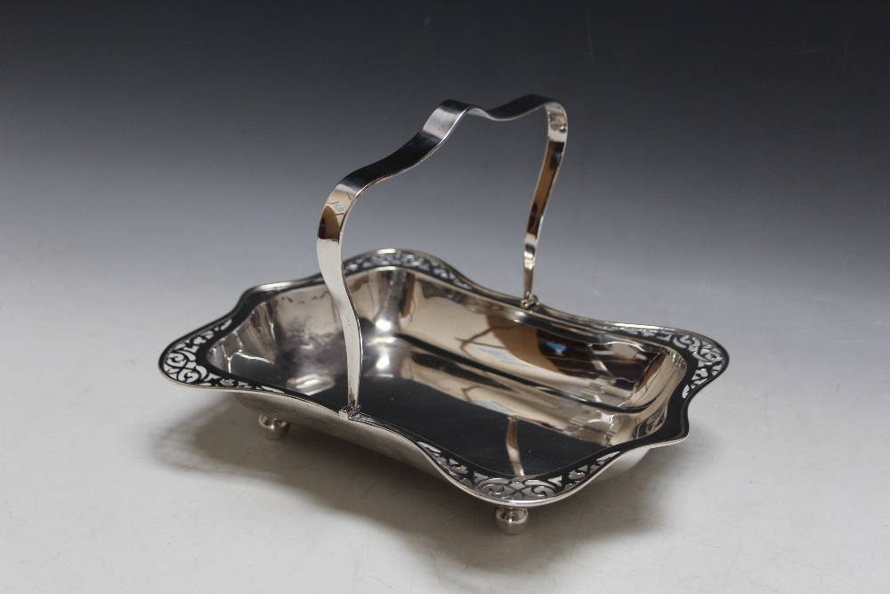 A HALLMARKED SILVER SWING HANDLED BASKET BY JC LTD - BIRMINGHAM 1946, with pierced edge detailing