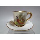 A ROYAL WORCESTER HAND PAINTED COFFEE CAN AND SAUCER, signed Jas Stinton, both items with game