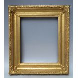 A 19TH CENTURY DECORATIVE GOLD FRAME, with acanthus leaf design to edges and corner