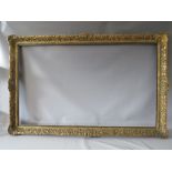 A LATE 19TH / EARLY 20TH CENTURY DECORATIVE GOLD FRAME WITH WOODEN SLIP, frame W 7 cm, slip rebate