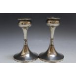 A PAIR OF HALLMARKED SILVER CANDLESTICKS BY S BLANCKENSEE & SON LTD - CHESTER 1927, in an Arts &