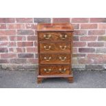 A SMALL ANTIQUE MAHOGANY CHEST OF FOUR DRAWERS, crossbanded to the top, raised on bracket feet, H 74