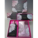 A NEW AND BOXED TED BAKER TRAVEL SET, comprising a luggage tag and passport holder, together with