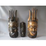 TWO LARGE CARVED HARDWOOD TRIBAL MASKS WITH DECORATIVE INLAY, tallest H 94 cm, together with a