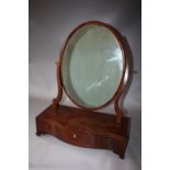 A REGENCY MAHOGANY AN INLAID DRESSING MIRROR, the oval mirror held by shaped supports and a