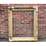 A LARGE 19TH CENTURY GOLD DECORATIVE SWEPT FRAME - WITH DAMAGES, frame W 17 cm, rebate 120 x 97 cm