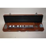 AN UNUSUAL WOODEN CASED ZITHER STYLE STRINGED INSTRUMENT