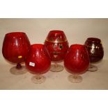 A COLLECTION OF FIVE DECORATIVE LARGE RED GLASS VASES ON STANDS, TALLEST H. 33 CM