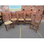 AN ANTIQUE MIXED SET OF FIVE OAK WICKER SEAT CHAIRS