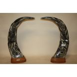 A PAIR OF LARGE CARVED BUFFALO HORNS ON WOODEN PLINTHS, H 48 CM