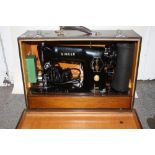 A CASED SINGER ELECTRIC 201K SEWING MACHINE WITH ACCESSORIES