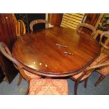 A LATE VICTORIAN MAHOGANY WIND-OUT DINING TABLE WITH TWO SPARE LEAVES RAISED ON FLUTED SUPPORTS -