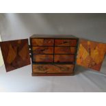 AN ORIENTAL INLAID TABLE CABINET, having two doors and single drawer, the doors opening to reveal