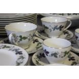 A LARGE COLLECTION OF ROYAL DOULTON 'BURGUNDY' PATTERN TEA AND DINNERWARE, comprising 12 tea cups,