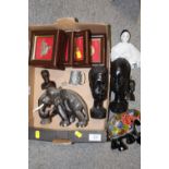 A BOX OF COLLECTABLES TO INCLUDE EBONISED CARVED WOODEN BUSTS, FRAME AND GLAZED CAP BADGES AND