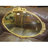 A GILT OVAL WALL MIRROR W-86 CM