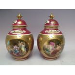 A PAIR OF ROYAL VIENNA GILDED PORCELAIN LIDDED VASES, each with blue beehive mark and titled in