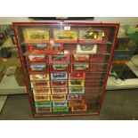 A GLASS WALL HANGING DISPLAY CASE, CONTAINING BOXED DIE CAST CARS, CABINET H 87 CM, W 68 CM