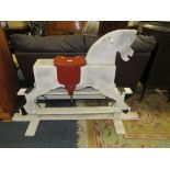 A WOODEN CHILDS TRESTLE ROCKING HORSE