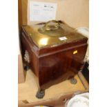 A BRASS LIDDED MAHOGANY COAL BOX RAISED ON PAW FEET OVERALL HEIGHT - 44CM