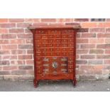 A CHINESE HARDWOOD APOTHECARY CHEST OF SLIM PROPORTIONS, having an arrangement of forty four drawers