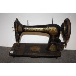 AN UNCASED VINTAGE SINGER SEWING MACHINE