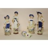 A COLLECTION OF FOUR GLAZED BISQUE STYLE FIGURES PLUS FOUR FLOWERS