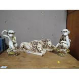 A PAIR OF CONTEMPORARY RESIN LIONS TOGETHER WITH A PAIR OF HUMOROUS MONKEYS