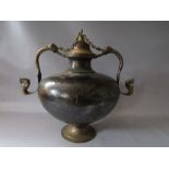 A LARGE VINTAGE EASTERN METAL DECORATIVE LIDDED VESSEL, with applied mask embellished handles, H