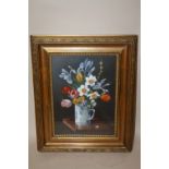 A GILT FRAMED AND GLAZED STILL LIFE OIL PAINTING OF FLOWERS IN A MUG SIGNED W. BADILELLEY LOWER