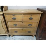 AN ANTIQUE PINE FOUR DRAWER CHEST ON BUN FEET H-89 W-89CM