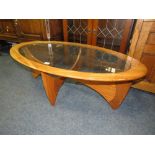 A RETRO TEAK AND GLASS TOPPED OVAL COFFEE TABLE W 120 cm