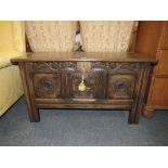 A VINTAGE CARVED OAK TRIPLE PANEL COFFER WITH KEY H-58 W-107 CM