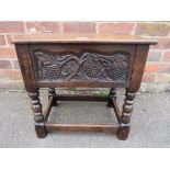 A SMALL CARVED OAK SEWING BOX RAISED ON BOBBIN TURNED SUPPORTS, H-46 W-48 CM